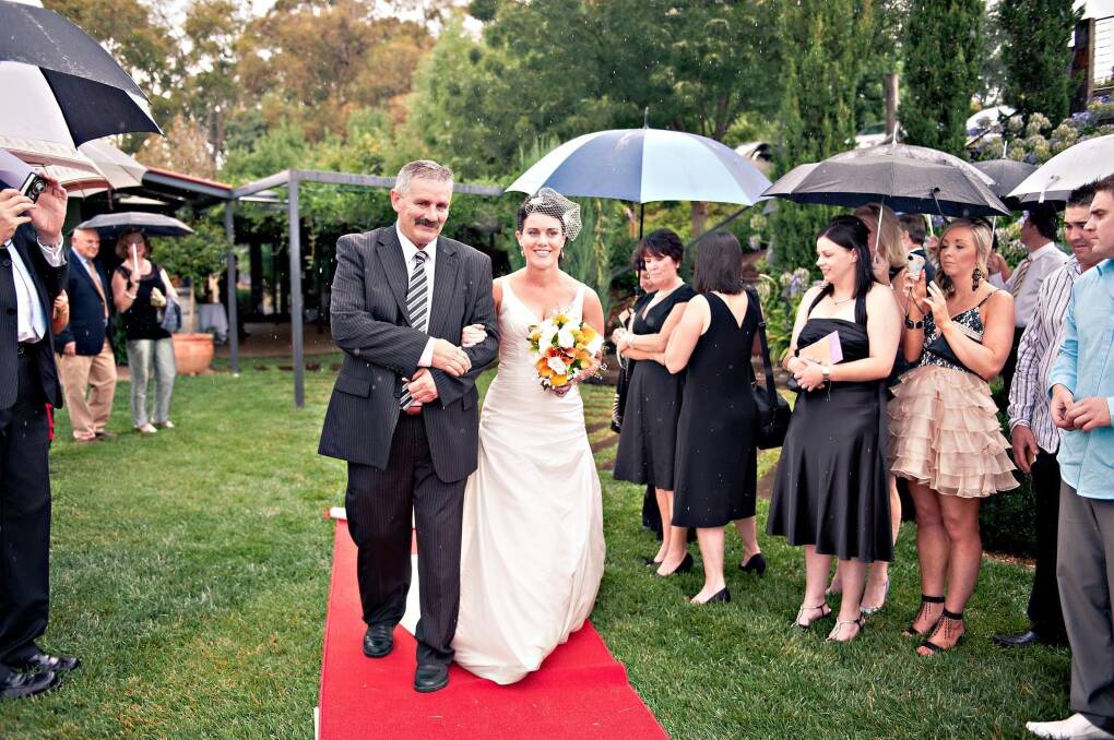 Orange-based graphic designer and Molong resident, Natasha Townsend is walked down the aisle by her late father, Wayne Foley, on her wedding day. Picture supplied.