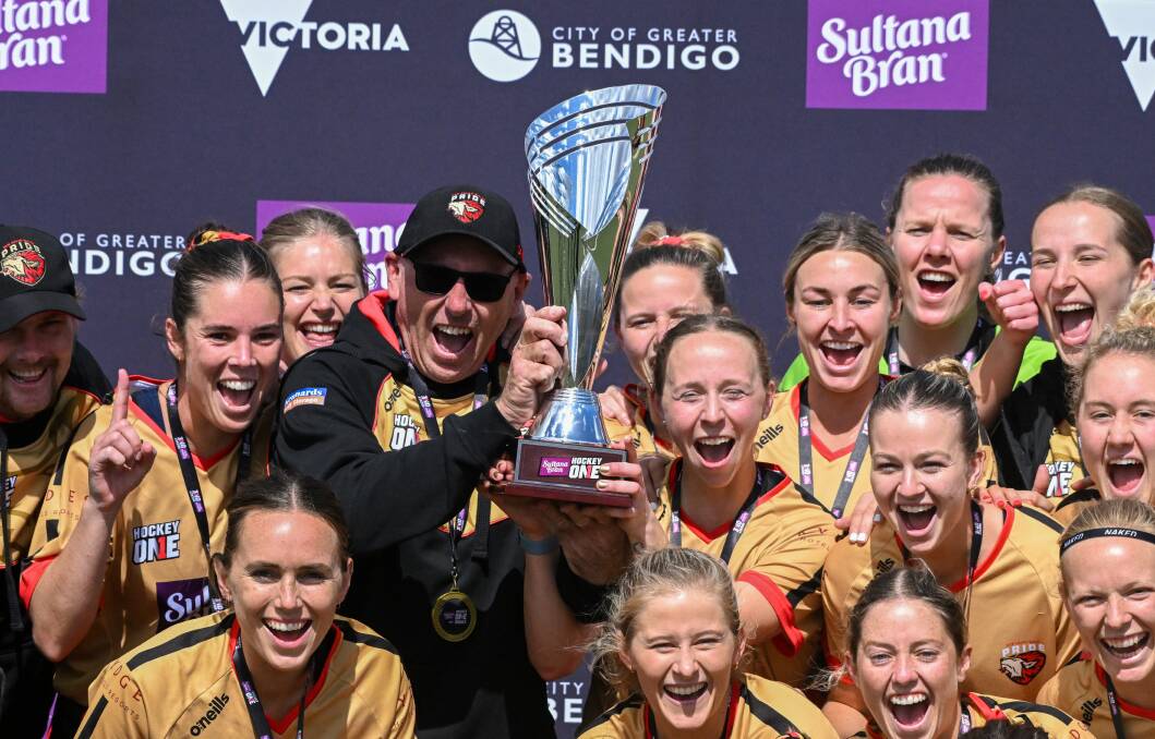 Peter Shea lifts the Hockey One trophy with his players. Picture from Bendigo Advertiser 